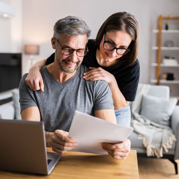 image of a husband and wife looking at bills